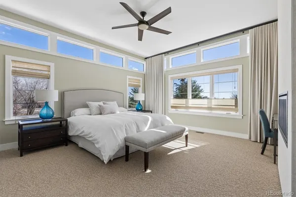 a bedroom with a bed and a large window