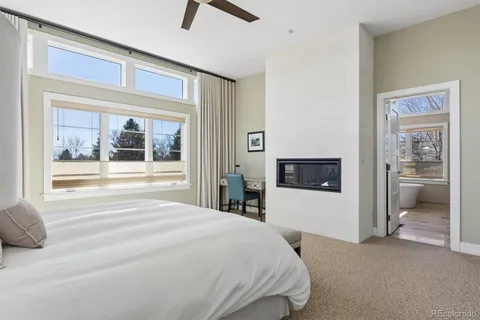 a bathroom with a double vanity sink a mirror a bathtub and window