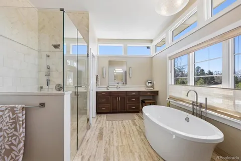 a bathroom with a bathtub sink and mirror