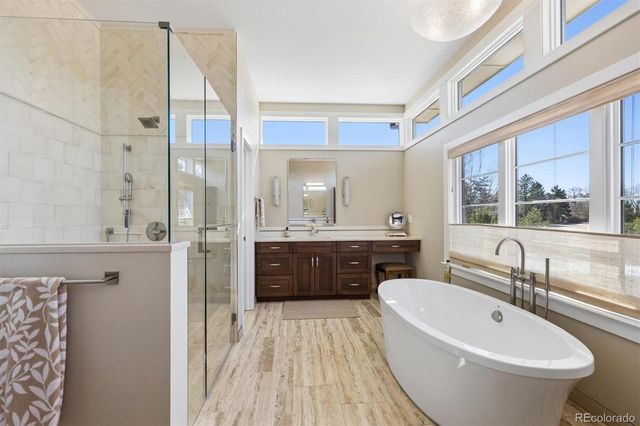 a bathroom with a bathtub sink and mirror