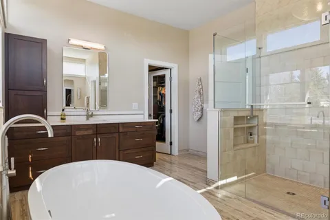 a view of walk in closet with clothes and shoes