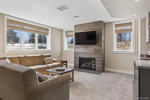 a living room with furniture fireplace and flat screen tv