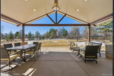 a view of a patio with table and chairs and potted plants