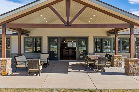 a swimming pool with outdoor seating and patio