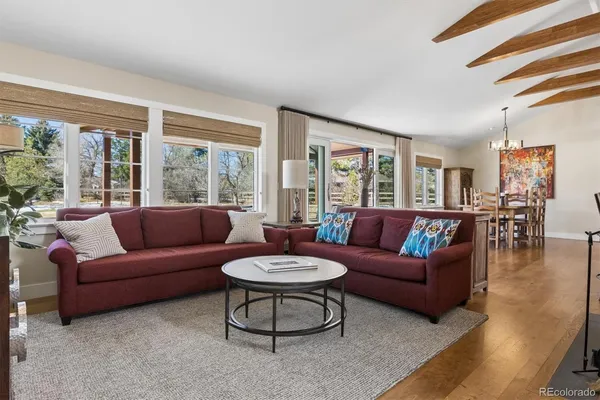 a living room with furniture a large window and a table