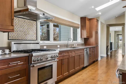 a kitchen with stainless steel appliances granite countertop a stove and a sink
