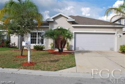 8876 Falcon Pointe Loop Fort Myers, FL 33912 - Photo 1 of 3 a front view of a house with garden