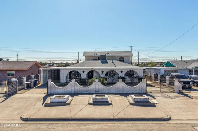 a kitchen with a stove and wooden floor