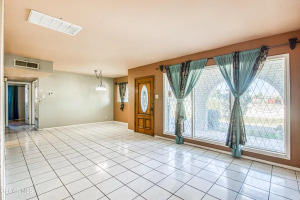 a bedroom with a large bed a chandelier and closet
