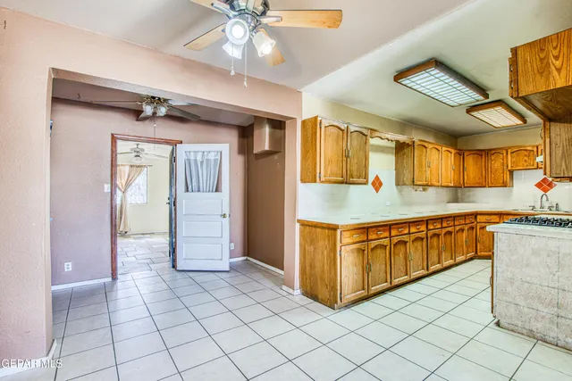 a kitchen with stainless steel appliances a stove a sink dishwasher and cabinets with wooden floor