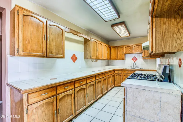 a bathroom with a granite countertop sink a large mirror and a bathtub