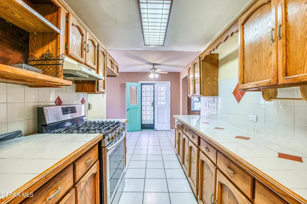 a kitchen with stainless steel appliances granite countertop a sink and cabinets