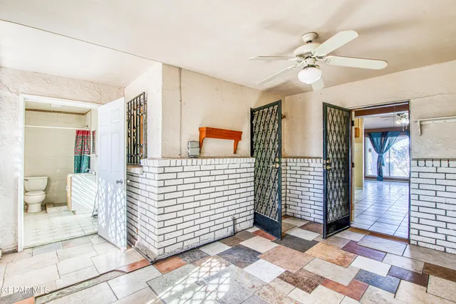 a view of a hallway with wooden shelves