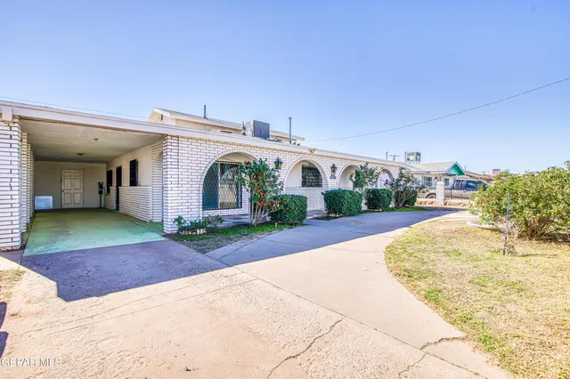 a view of a white house with a yard