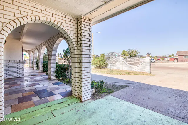 a view of a house with potted plants