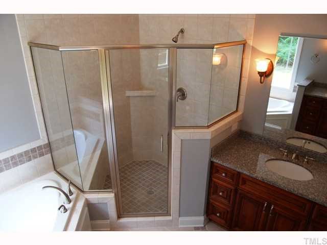 6912 Johnson Mill Road Bahama, NC 27503 - Photo 7 of 12 a bathroom with a sink a mirror a vanity and shower