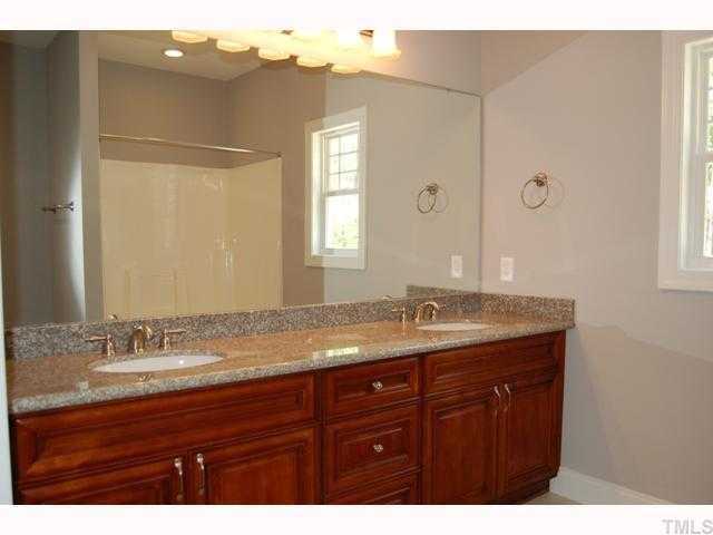 6912 Johnson Mill Road Bahama, NC 27503 - Photo 9 of 12 a bathroom with a granite countertop sink and mirror