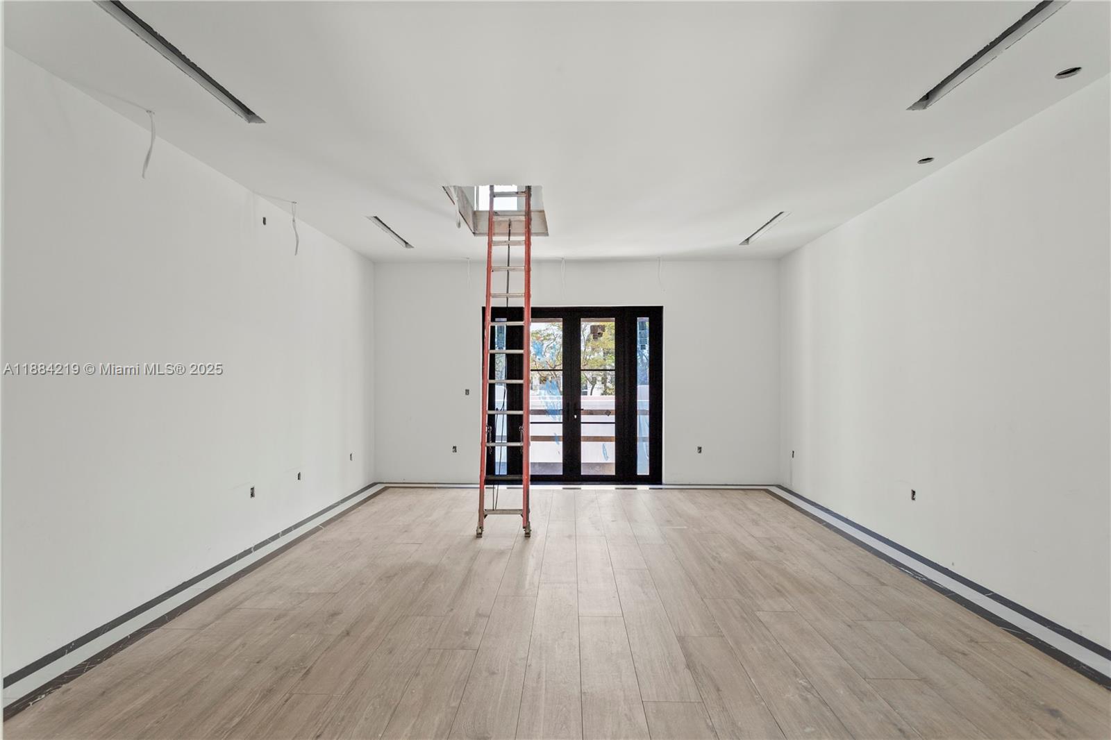 6460 Southwest 94th Street Pinecrest, FL 33156 - Photo 26 of 43 wooden floor in an empty room with a window