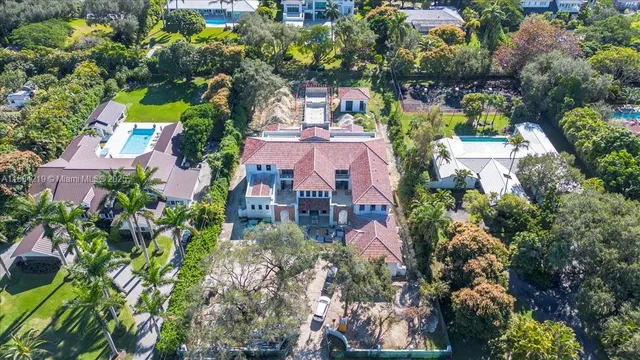 an aerial view of residential houses with outdoor space and street view