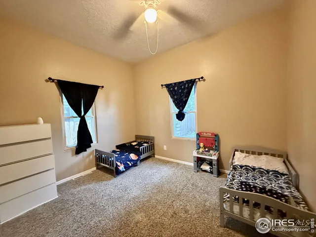 a bedroom with furniture and a window