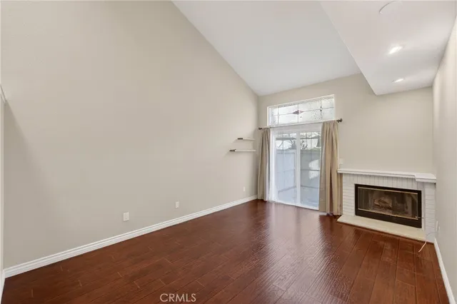 wooden floor in an empty room with a fireplace