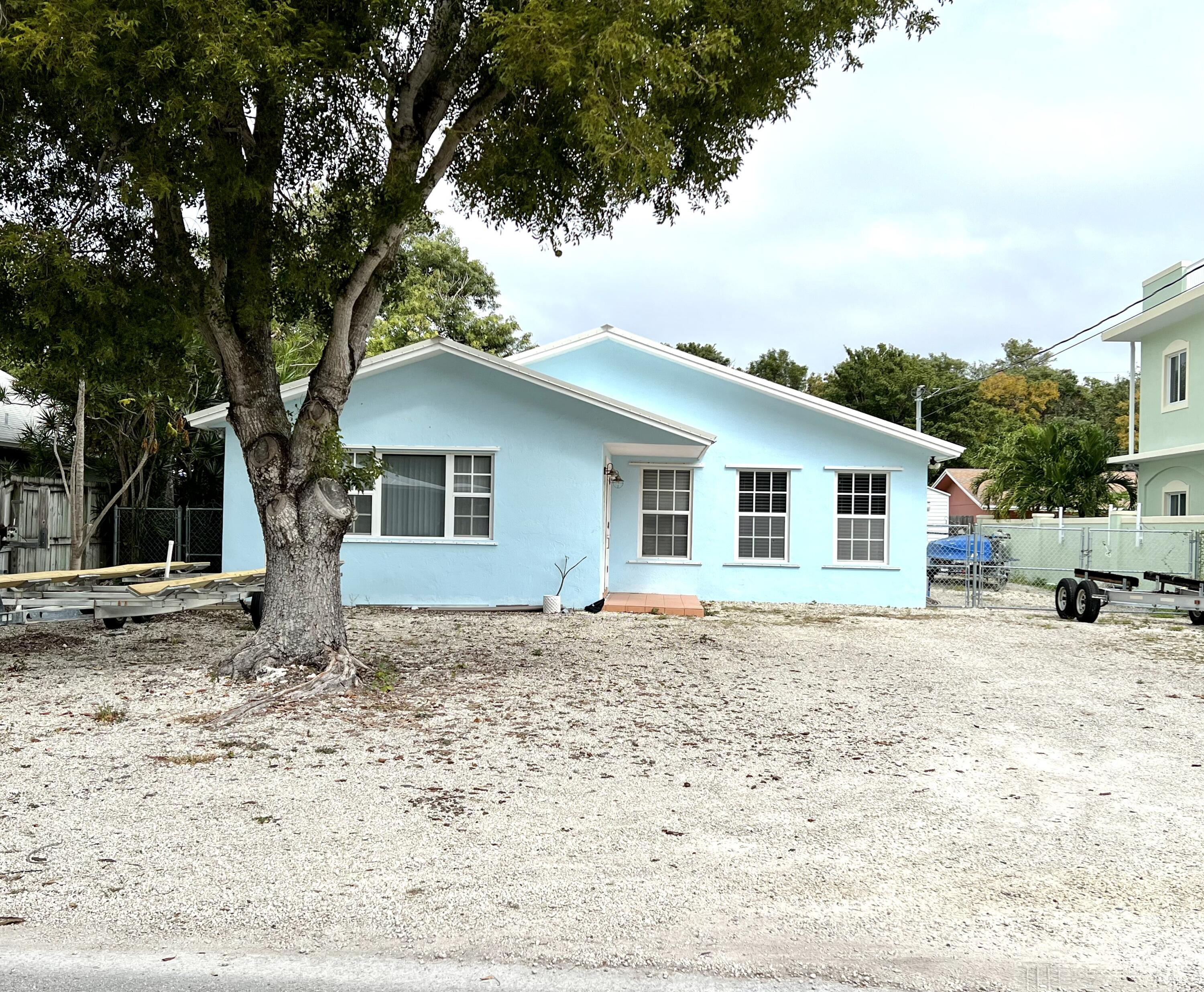a view of a house with a yard covered in snow