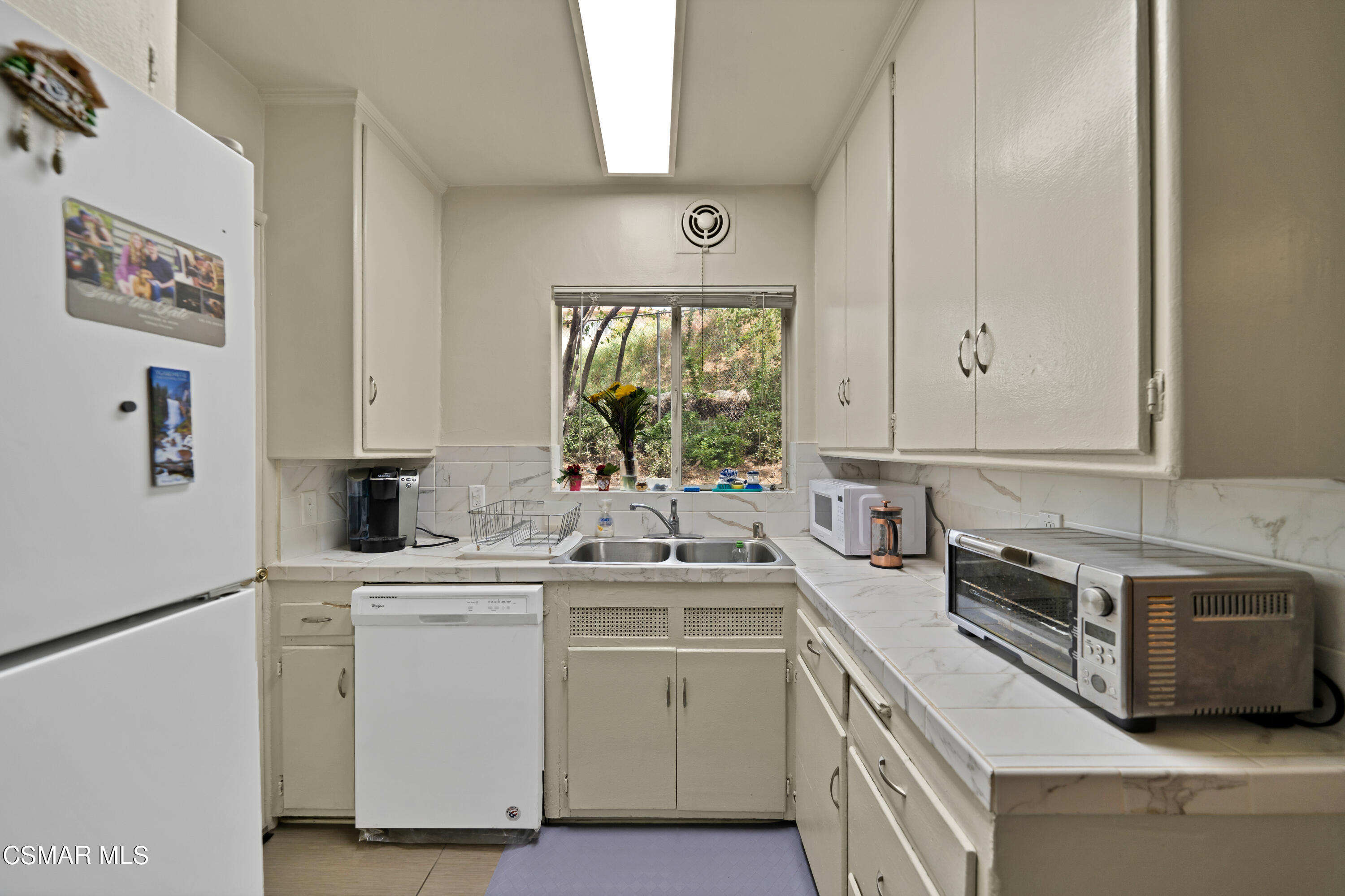 1550 North Verdugo Road Glendale, CA 91208 - Photo 44 of 61 a kitchen with a sink white cabinets and white appliances