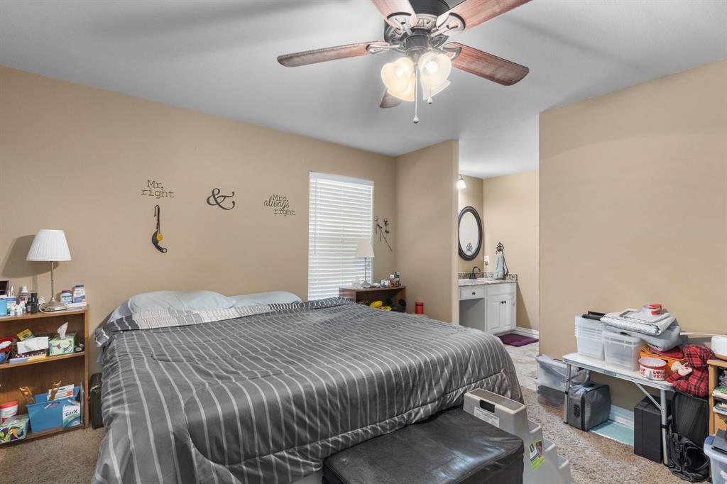 4504 Jennings Avenue Wichita Falls, TX 76310 - Photo 15 of 26 a bedroom with a bed and a chandelier