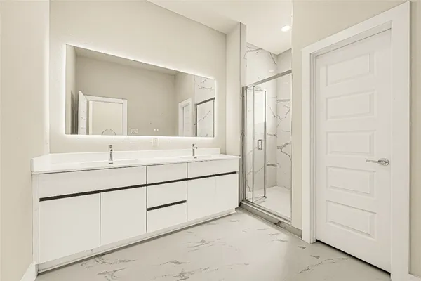 a bathroom with a double vanity sink mirror and