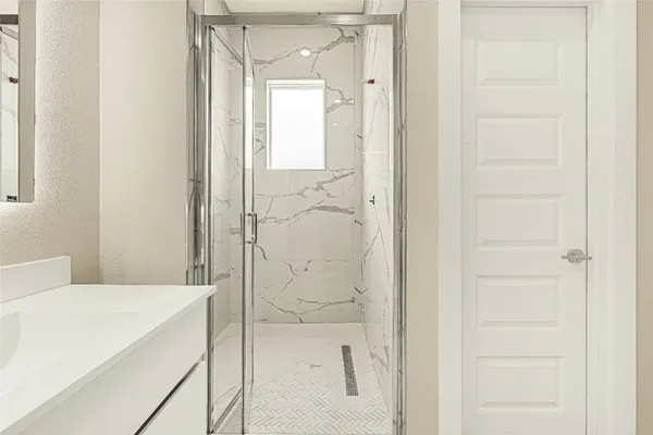 a bathroom with a bathtub and shower