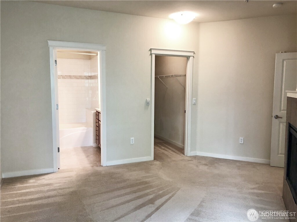 4321 Issaquah-Pine Lake Road Southeast, Unit 408 Sammamish, WA 98075 - Photo 17 of 33 an empty room with closet and a bathroom