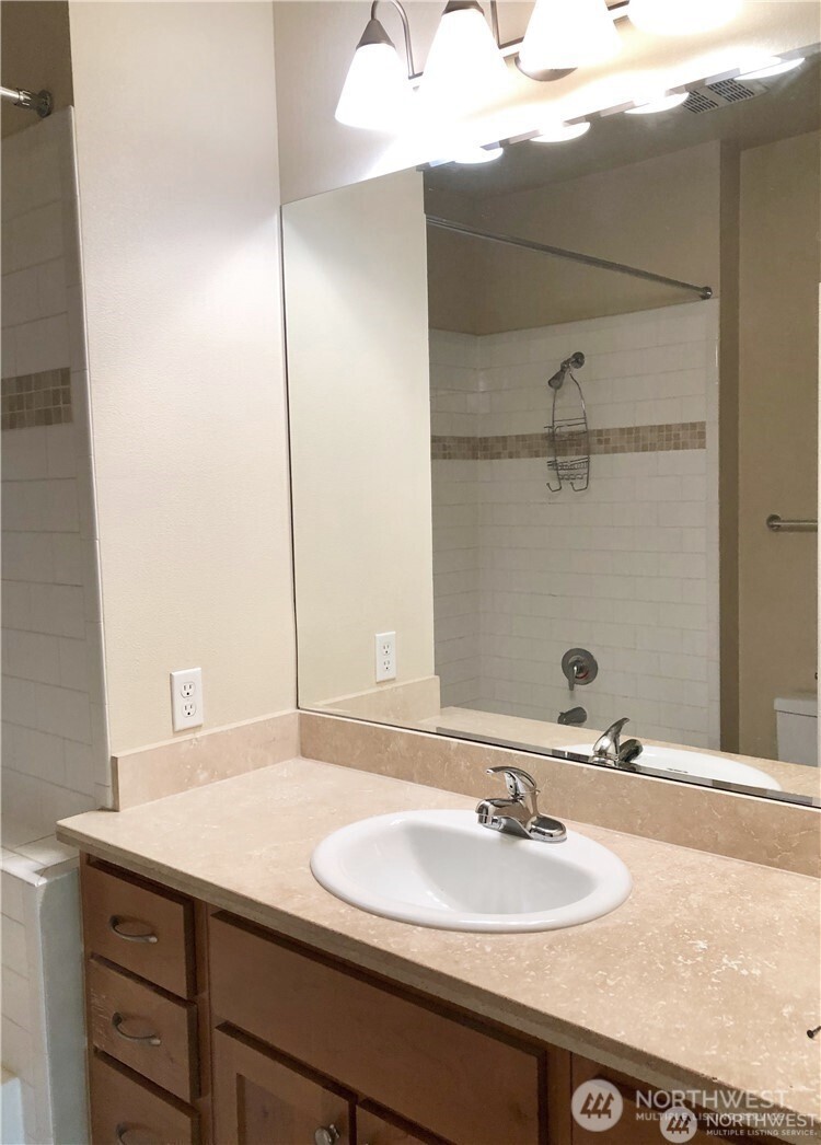 4321 Issaquah-Pine Lake Road Southeast, Unit 408 Sammamish, WA 98075 - Photo 20 of 33 a bathroom with a sink and a mirror