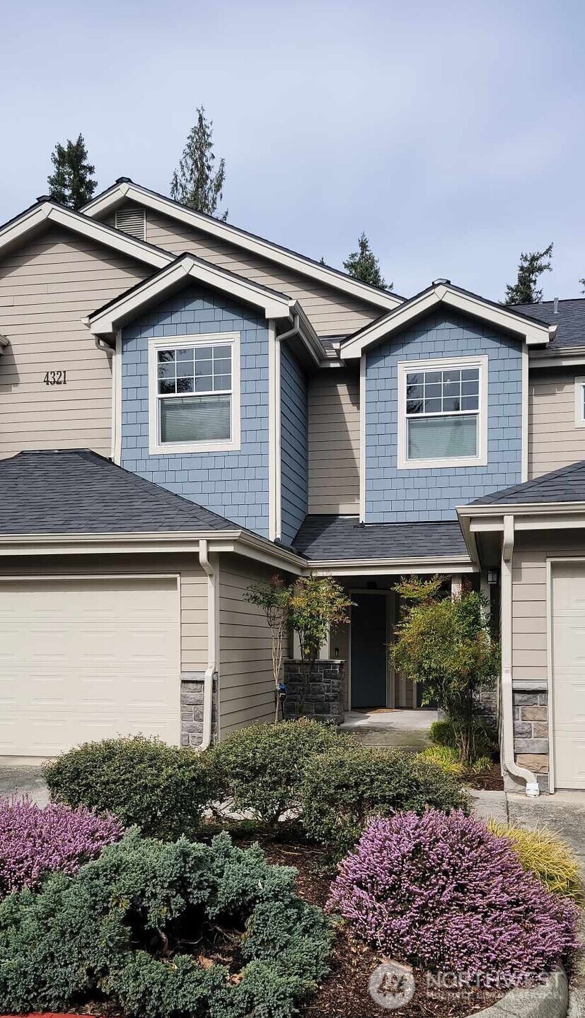 4321 Issaquah-Pine Lake Road Southeast, Unit 408 Sammamish, WA 98075 - Photo 26 of 33 a front view of a house with garden