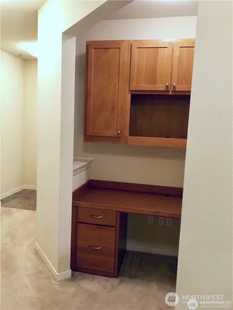 a room with a desk and cabinets