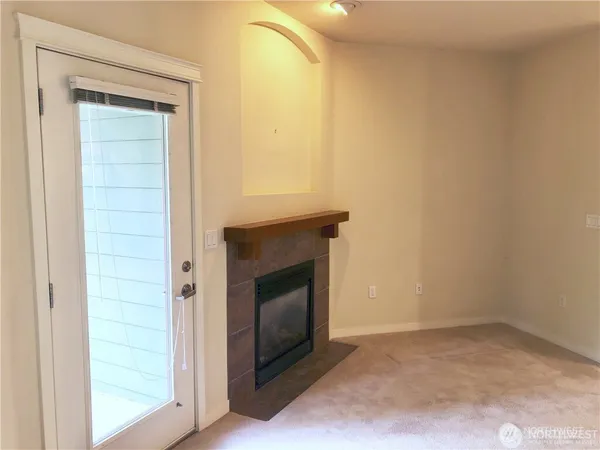 a view of an empty room and fire place