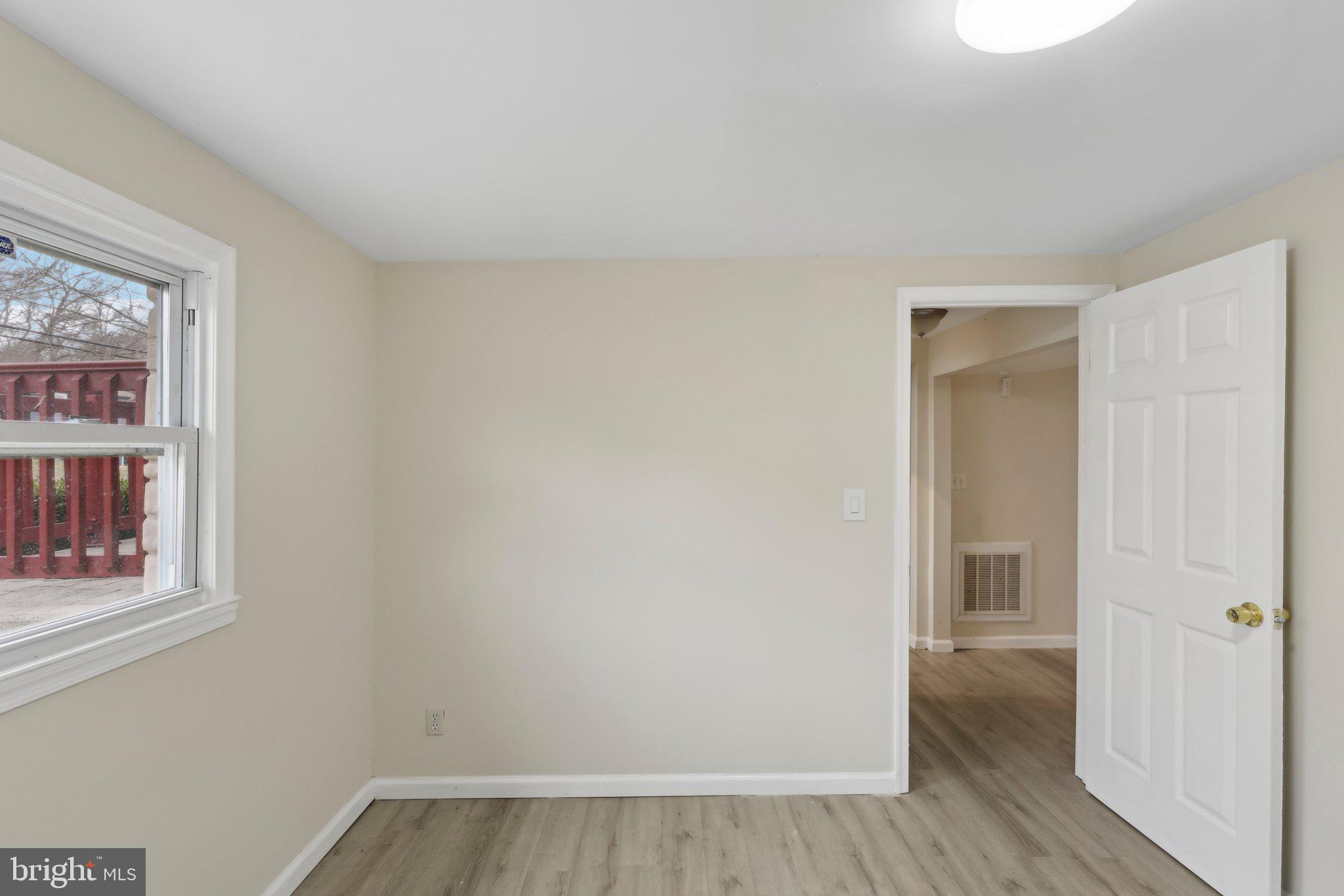 117 Susan Drive Jackson, NJ 08527 - Photo 18 of 43 a view of an empty room with wooden floor and a window