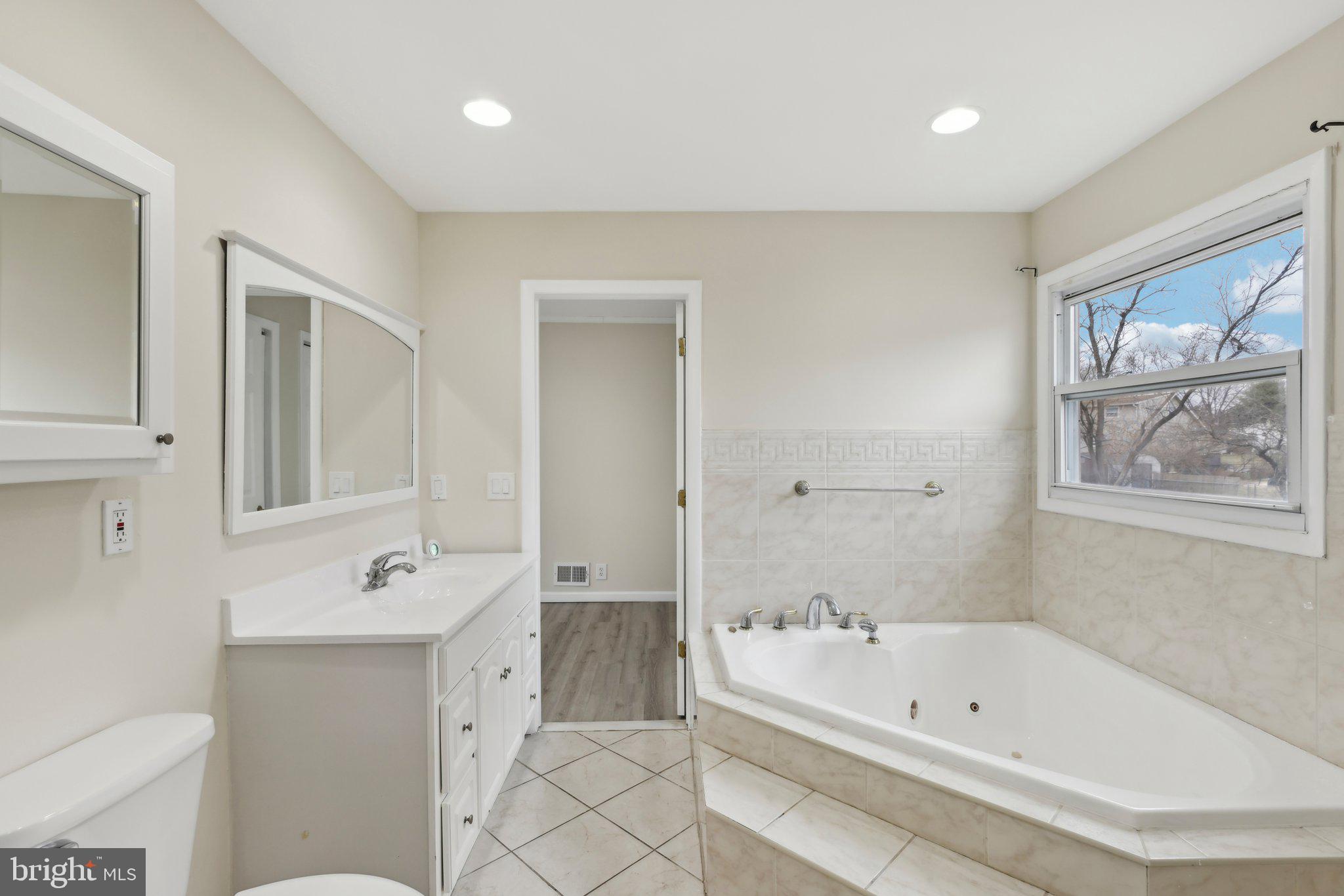 117 Susan Drive Jackson, NJ 08527 - Photo 31 of 43 a bathroom with a tub a sink and a mirror