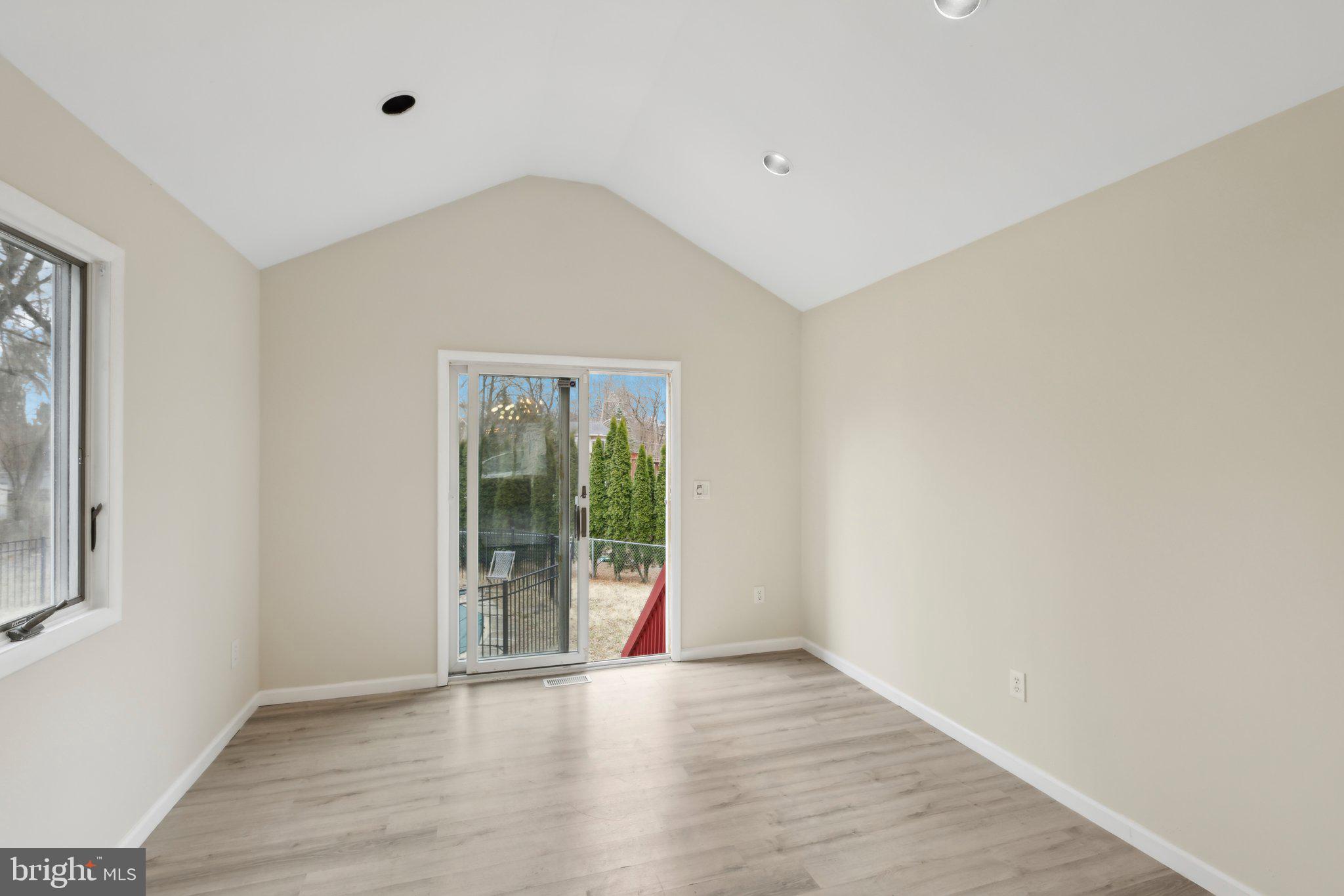 117 Susan Drive Jackson, NJ 08527 - Photo 8 of 43 an empty room with wooden floor and windows