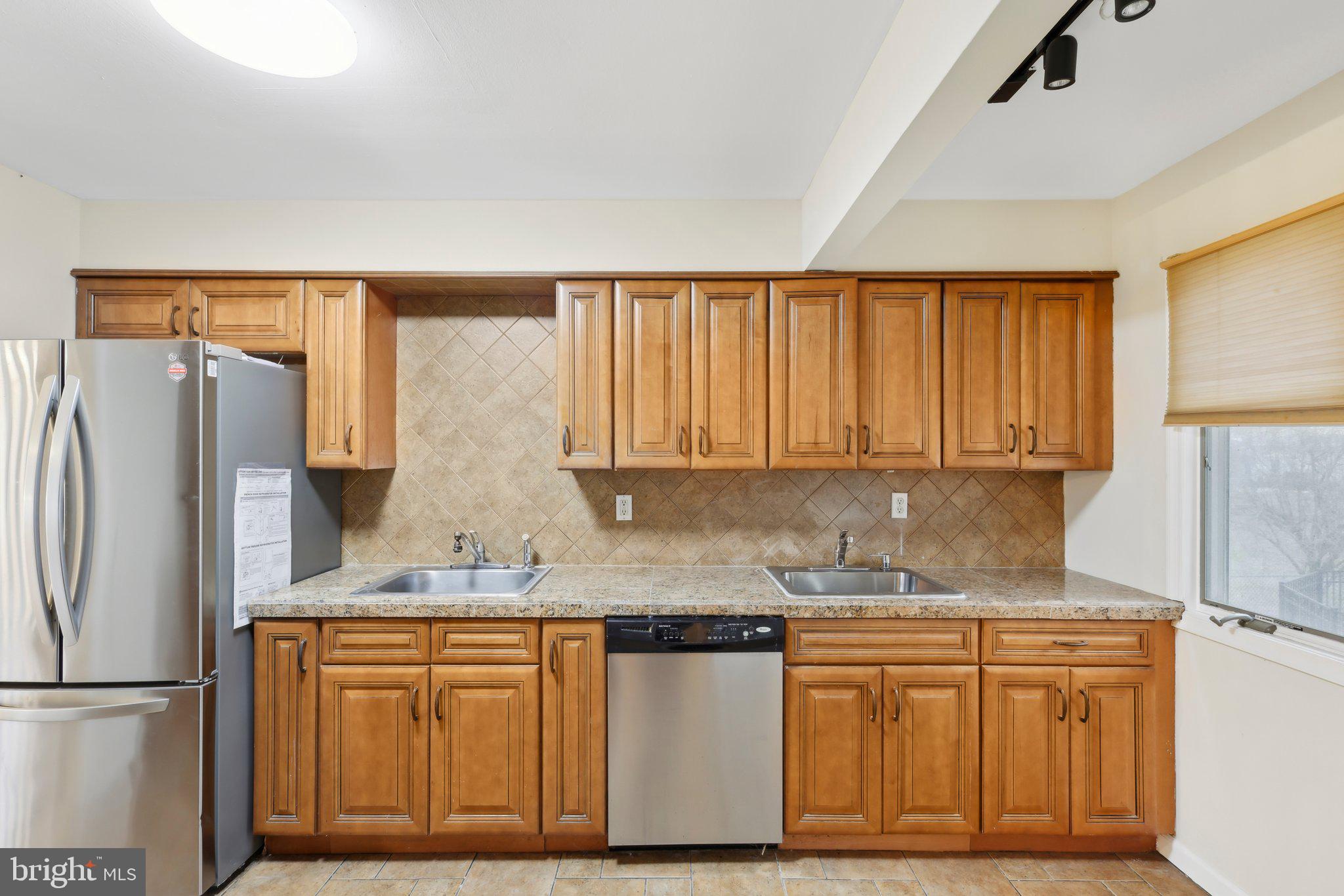 117 Susan Drive Jackson, NJ 08527 - Photo 10 of 43 a kitchen with stainless steel appliances granite countertop a refrigerator sink and cabinets
