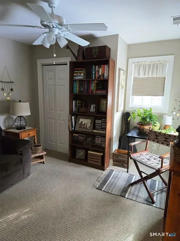 a living room with furniture a window and a chandelier