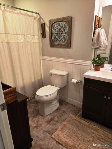 a bathroom with a toilet and a sink