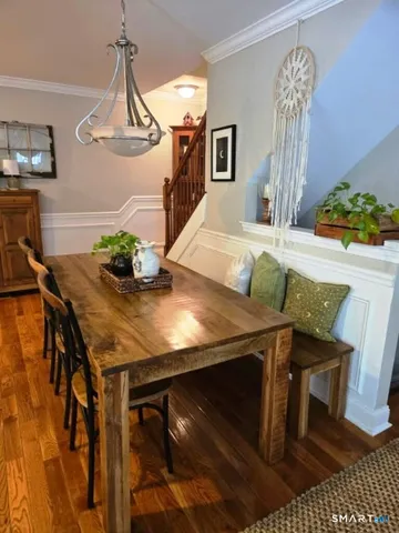 a view of a dining room with furniture and chandelier