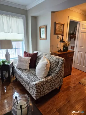 a living room with a couch and wooden floor