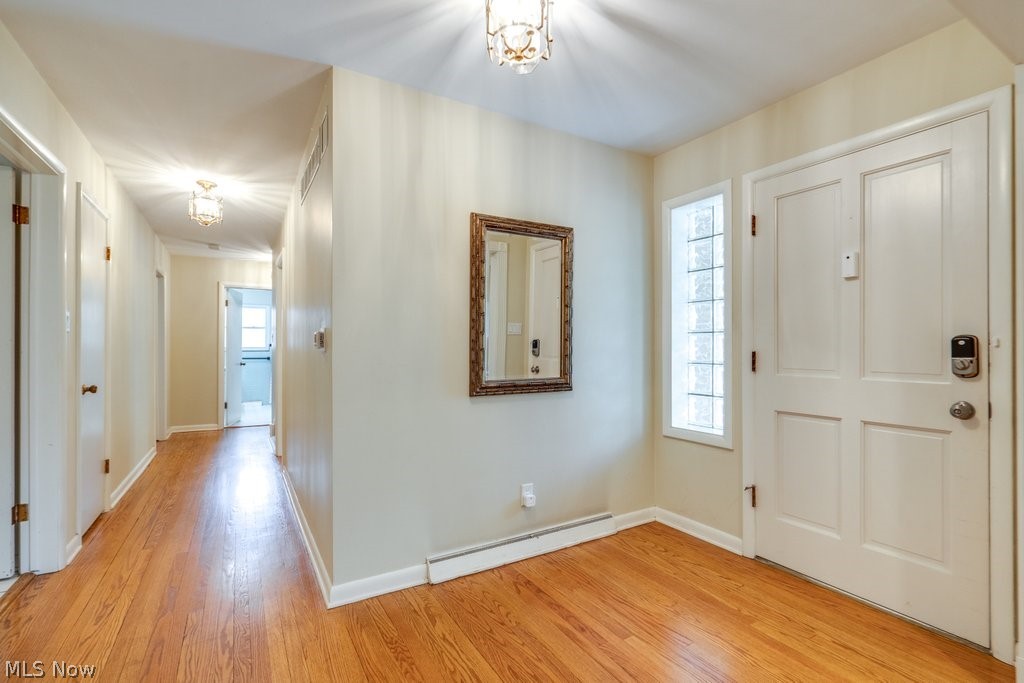 3060 Chamberlain Road Akron, OH 44333 - Photo 4 of 47 Foyer entrance featuring a wealth of natural light, a baseboard heating unit, and light hardwood / wood-style flooring