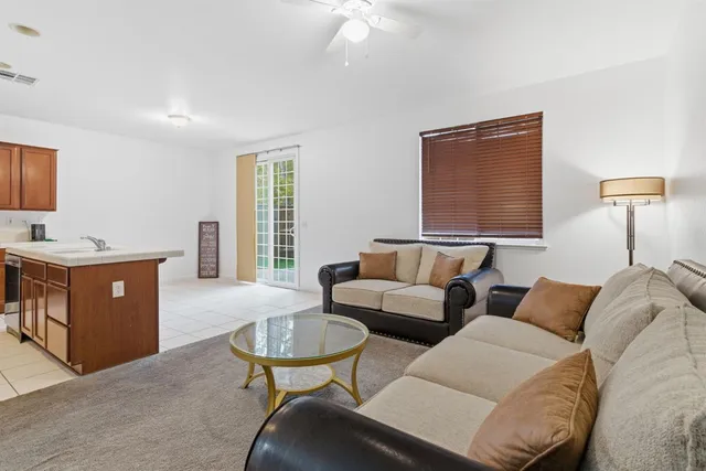 a kitchen with stainless steel appliances granite countertop a stove a refrigerator and a fireplace