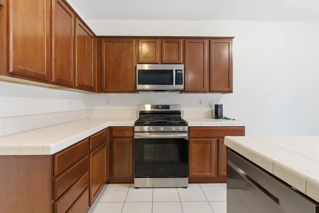 a utility room with a sink a vanity and a mirror