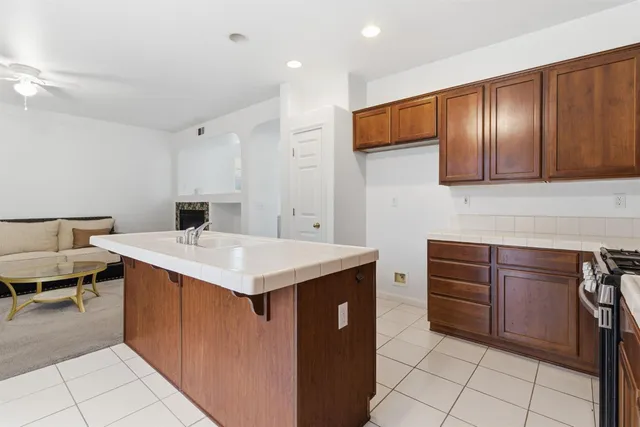 a kitchen with stainless steel appliances granite countertop a stove microwave and sink