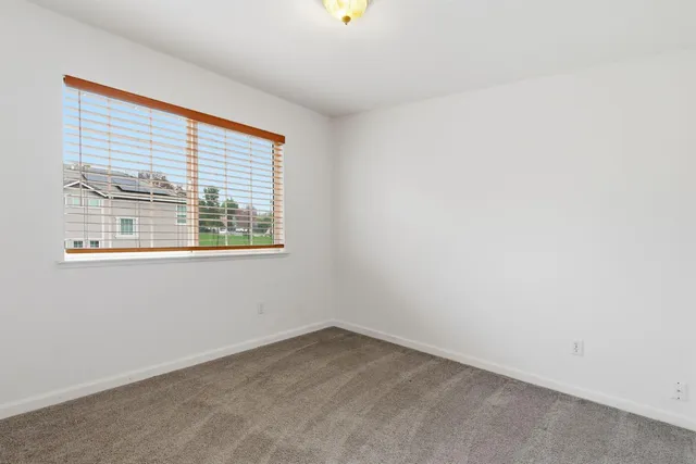 a view of a street with wooden fence