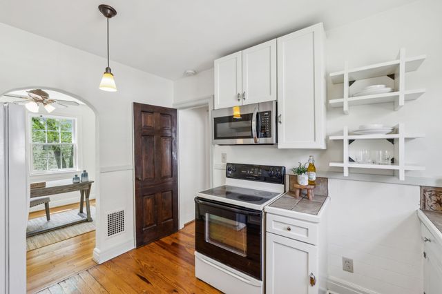 a living room with furniture a wooden floor and a sink