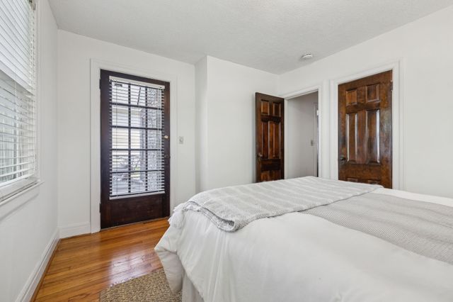 a wooden bench sitting in front of a building